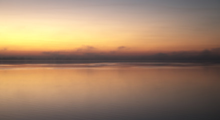 Fototapeta na wymiar Sunrise with fog over lake