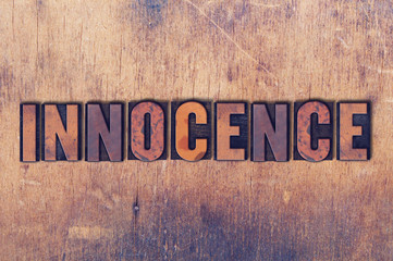 Innocence Theme Letterpress Word on Wood Background