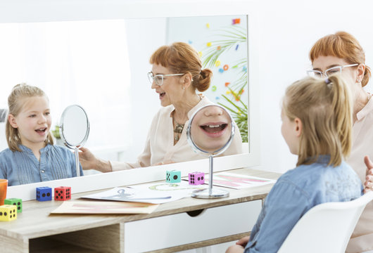 Speech therapist using mirror exercises