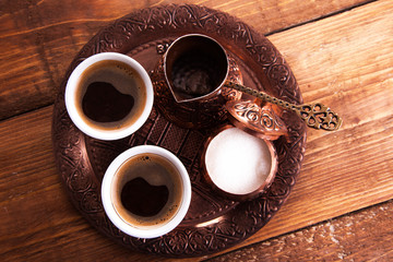 Fototapeta na wymiar Antique bronze pitcher and coffee cup set with dates in a tray isolated on a white background,Turkish coffee set on wooden background.