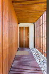 Entryway to a modern house wooden front door 