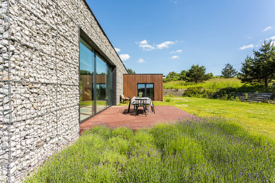 Pebble wall house with modern architecture tarrace