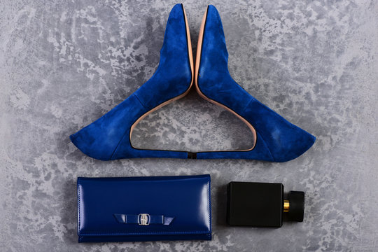 Shoes and clutch in dark blue color with perfume bottle