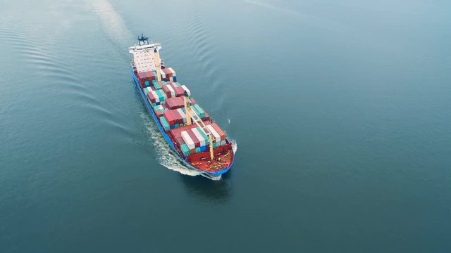 Aerial view of container vessel sailing in open sea