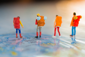Miniature people : Backpacker travel to destinations on the map. Using as travel business concept