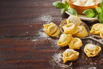 Freshly made uncooked Italian tortellini pasta - obrazy, fototapety, plakaty