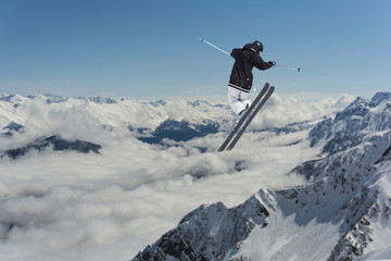 Naklejka na ściany i meble Jumping skier in mountains. Extreme sport, freeride.