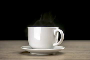 Close up shot of a steaming coffee in white cup