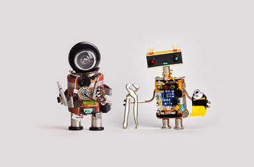 Repairman toy robots with screwdrivers tongs pliers tube of glue. Friendly service workers, funny...