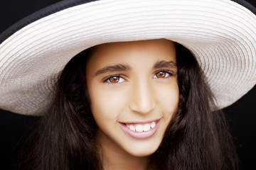 Close up portrait of a young african american girl laughing with sun hat