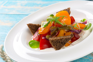 Fresh vegetable salad on wooden background