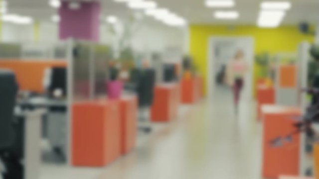 Blurred View of the Corridor with Walking People There. Creative Office Interior with Bright Colors.