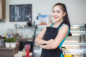 Asian barista woman standing for present cafe with attractive smiling at front of coffee shop. Woman with owner business concept.