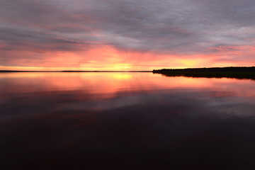 Sunset over the surface of the lake water