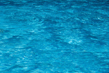 Texture of water of the pool is blue. Textural background