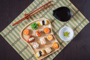 Fototapeta na wymiar Sushi with salmon, prawn, avocado, cream cheese. Sushi menu. Japanese food.Top view.