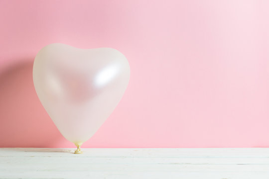 Valentine heart balloon on pastel pink background