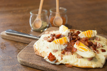 italian pizza ontop with bacon and boiled egg
