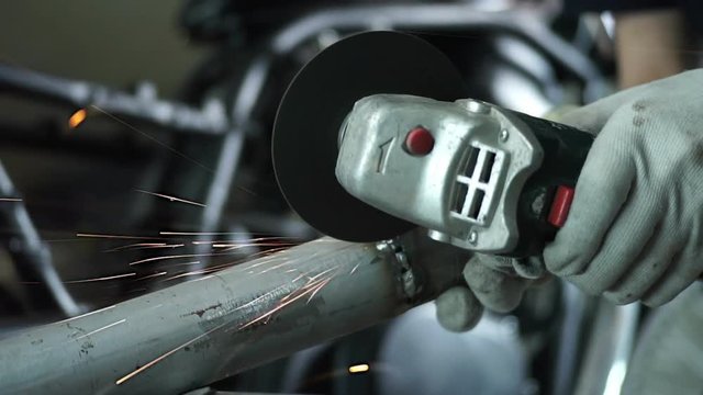the mechanic works with metal sparks.