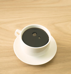hot black coffee on wood table, vintage style