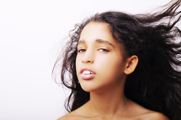Portrait of a little girl flipping her hair isolated on white