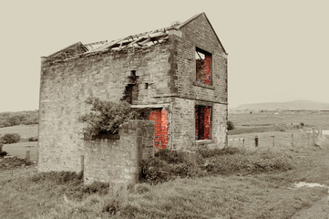 derelict old farmhouse or barn in the english countryside 
