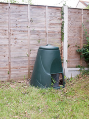 a green compost bin outside in garden