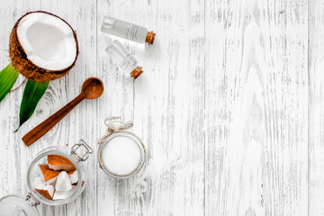 Organic cosmetics with coconut. Coconut oil on wooden background top view copyspace