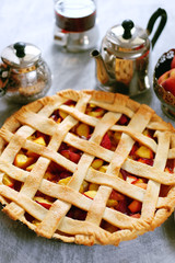 Tasty summer fruit pie with peach filling, tea and cookies