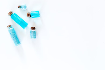 Sea cosmetics. Sea salt, blue clay and lotion on white background top view copyspace