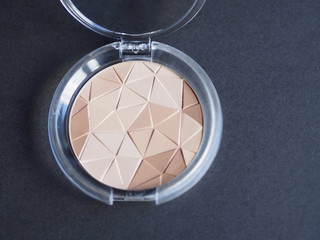 Compact powders on black background