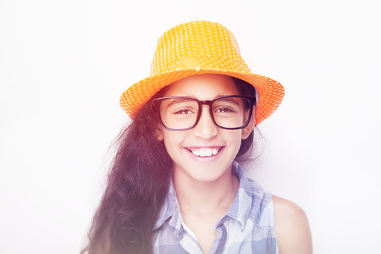 Image of a beautiful African young girl wearing glasses and hat