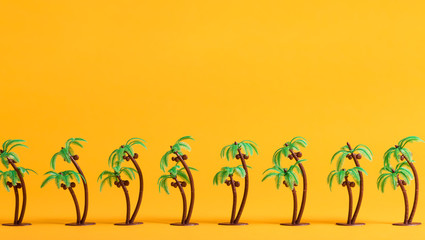 Tropical theme with little palm trees on a yellow background