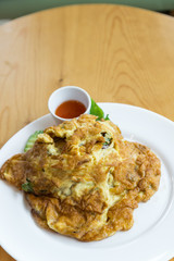 Thai Omelet  with jusmine steamed rice on wood table background