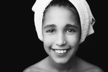  A little smiling girl with a towel on her head