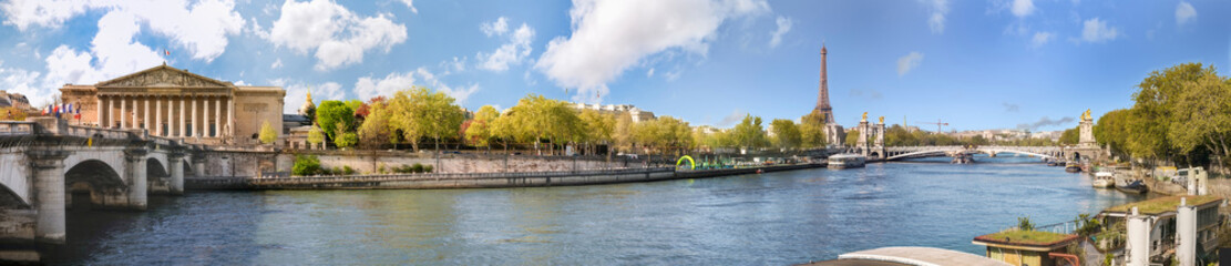 Panoramic view of Paris over river Seine with Alexander III bridge, Tour Eiffel and Assemblee Nationale