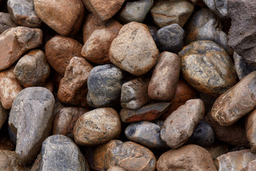 Background of many rough wet stones after rain