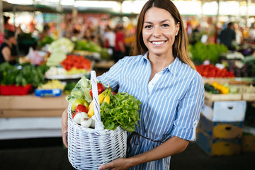 Portrait of beautiful woman holding shopping basket