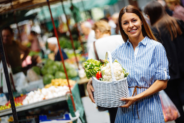 Portrait of beautiful woman holding shopping basket
