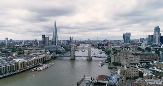 Aerial descending view of the skyline of the City of London with Tower bridge and the river Thames