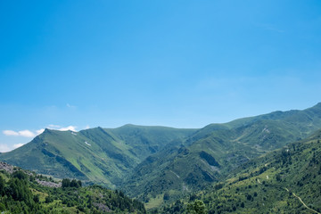 Obraz premium Mountain peaks meadows and forests in Grana Valley, Cuneo, Piedmont, Italy.