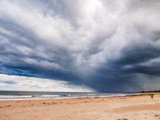 Storm clouds gathering above the beach of the 'Sands of Forvie' National Nature Reserve, Scotland, UK