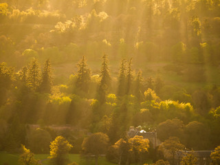 Beam of Sun rays shining over trees. Stirlingshire, Scotland, UK