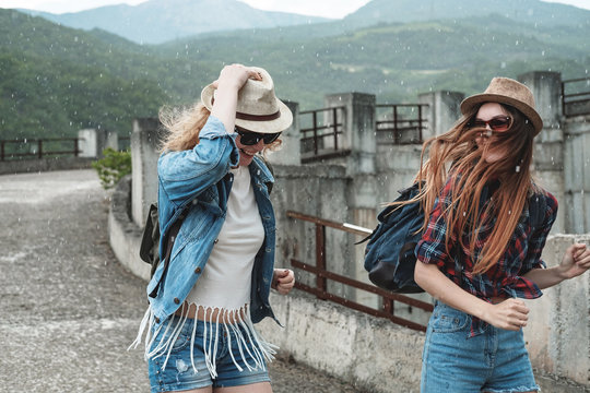 Two girls in hats traveling through ruins