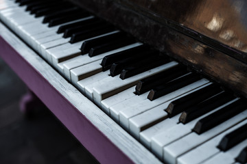 Fototapeta na wymiar Broken piano keys of an old classic acoustic piano