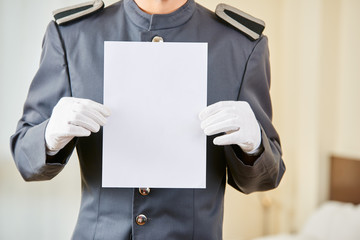 Hotel concierge holding empty paper