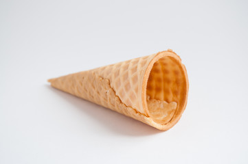 Empty waffle cone for ice cream on a white background.