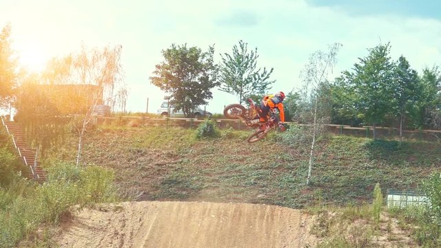 Slow Motion Extreme Motocross Rider on dirt track