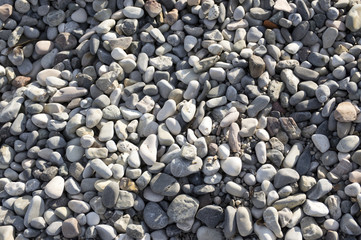 Group of white, grey and light brown stones background, pebbles beach