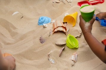 Fototapeta na wymiar Children Playing In The Sand